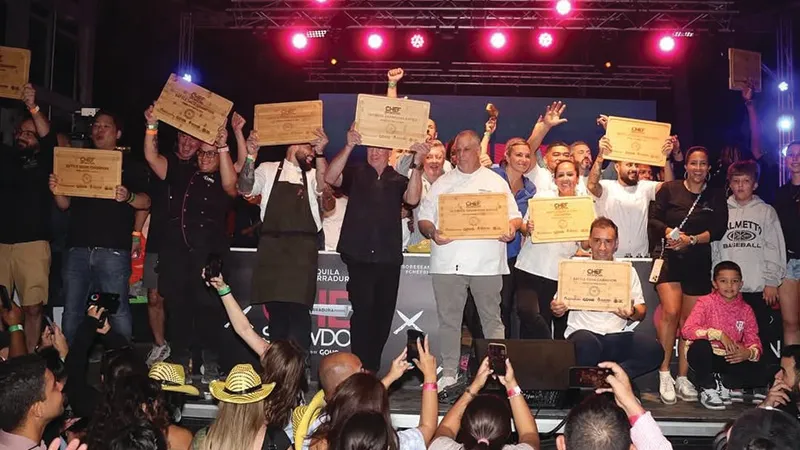 Chef Showdown winners celebrating on stage with plaques