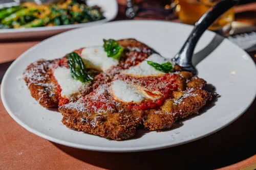 Chicken parmesan platter served family-style at the dinner series