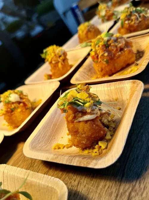 Crispy seafood bites served on palm-leaf tasting plates
