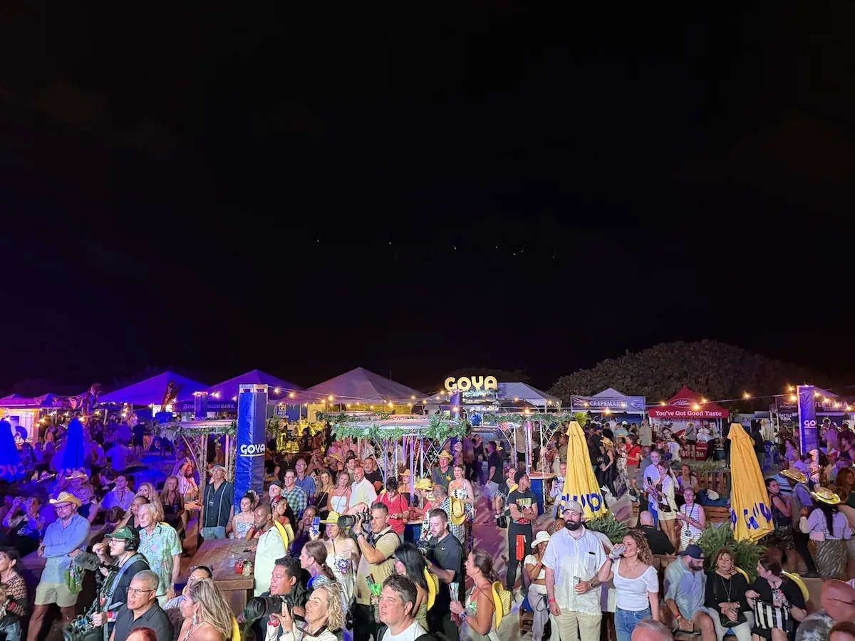 Crowd at night beneath the GOYA sign