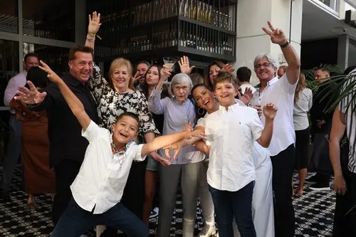 Guests cheering together at a festival dinner