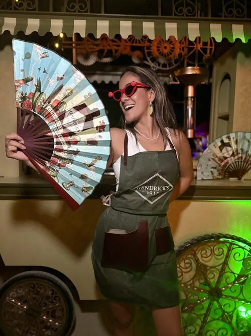 Hendrick's Gin host posing with a decorative hand fan