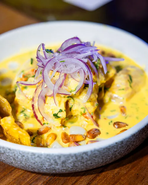Peruvian-style seafood bowl with red onion and corn